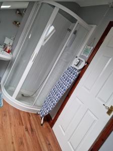 an open door with an umbrella on top of it at Cute loft apartment sleeps 4 in Antrim