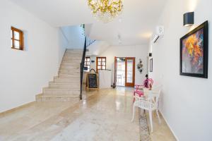 a living room with a staircase and a chandelier at Mel Town in Antalya