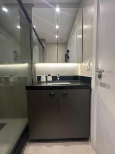 a bathroom with a sink and a shower at Loft no Bairro Auxiliadora in Porto Alegre