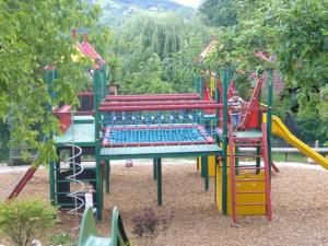 a playground with a slide and a play structure at Hotel Restaurant - Häuserl im Wald Graz in Graz