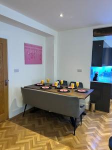 a dining room with a table and a tv at Quirky getaway @ The Old Bakery in Bristol