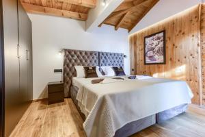a bedroom with a large bed and wooden floors at Loli in Jezera