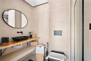 a bathroom with a sink and a mirror at Chic Studio with a Bath Tub, Pool & Gym near Golf Club in Dubai