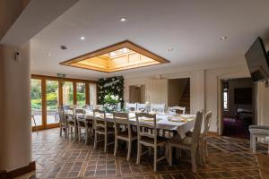 a dining room with a long table and chairs at Blackgreaves Farmhouse in Lea Marston
