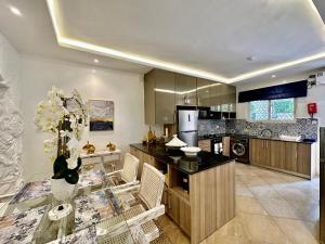 a kitchen with a table and chairs in a room at Amani Luxury Apartments in Diani Beach