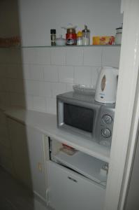 a microwave sitting on top of a counter in a kitchen at Buda Castle Apartments in Budapest