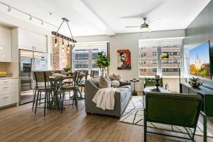 a living room with a couch and a table at Chic 4Bed Oasis Steps from French Quarter Magic! in New Orleans