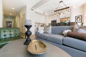 a living room with a couch and a table at Chic 4Bed Oasis Steps from French Quarter Magic! in New Orleans +57 photos