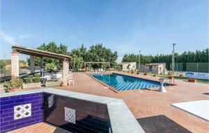 a large swimming pool with a gazebo and a pool at Beautiful Home In Grammichele With Kitchenette in Grammichele