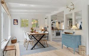 a kitchen with a table and chairs and a blue cabinet at Beautiful Home In Vig With Wifi in Vig