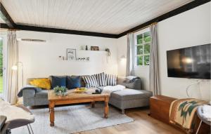 a living room with a couch and a table at Gorgeous Home In Hadsund With Wifi in Hadsund