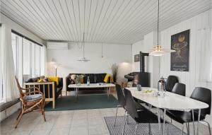 a living room with two tables and a couch at Awesome Home In Pandrup With Kitchen in Rødhus