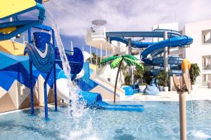 a water slide in a pool in a resort at Servatur Puerto Azul in Puerto Rico de Gran Canaria