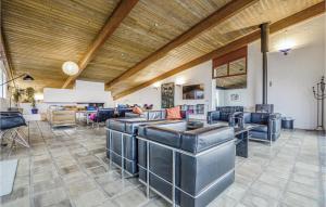Cette grande chambre dispose d'un mobilier en cuir et d'un plafond en bois. dans l'établissement Stunning Home In Knebel With House Sea View, à Knebel