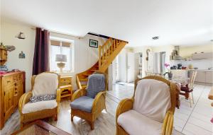 a living room with chairs and a staircase at Awesome Home In Dol-de-bretagne With 2 Bedrooms in Dol-de-Bretagne