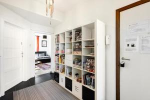 a hallway with white walls and white shelves at Chambres en appartements partagés in Liège
