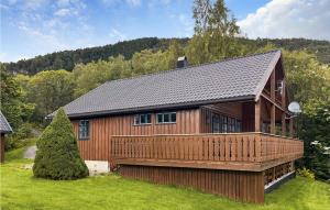 a large wooden house with a large deck at Nice Home In Midsund With Kitchen in Midsund