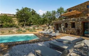 a pool with lounge chairs and a house at Awesome Home In Feliceto With House A Mountain View in Feliceto