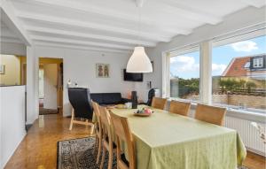 a dining room and living room with a table and chairs at 3 Bedroom Stunning Home In Skagen in Skagen