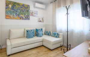 a living room with a white couch and blue pillows at Awesome Home In Mlaga With 2 Bedrooms And Wifi in Málaga