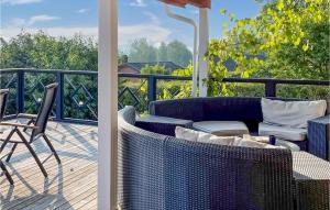 a patio with a couch and chairs on a deck at Amazing Home In Ydre With Wifi in Idebo