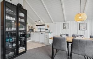 a kitchen and dining room with a table and chairs at Amazing Home In Tarm With Wifi in Tarm