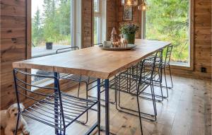 a kitchen with a wooden table and some chairs at Beautiful Home In Eggedal With 4 Bedrooms in Eggedal