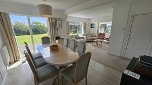 a living room with a dining room table and chairs at Heathfield in Saint Mawes