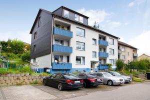 a group of cars parked in front of a building at Ferienwohnung zur Nordhelle in Herscheid