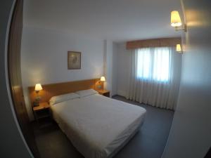 Postel nebo postele na pokoji v ubytování Apartamentos Turísticos Roc Del Castell