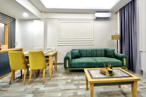 a living room with a green couch and a table at North Blue Life in Istanbul