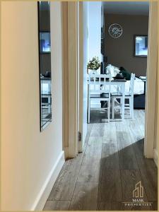 a kitchen and dining room with a table and chairs at Minehead Suite in Minehead