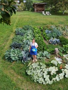 a woman standing in a garden of vegetables at Haflingerhof in San Genesio Atesino