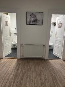 a bathroom with two toilets and two mirrors at Hostel Jasmin in Prague