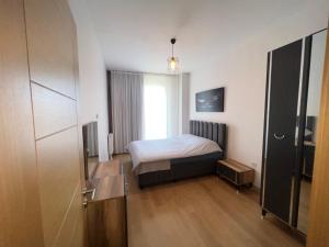 a small bedroom with a bed and a window at New Furnished Flat Central Location Free WIFI AC in Esenyurt