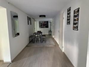 a hallway with a table and chairs in a room at L8 Street - Leimen - Basement floor in Leimen