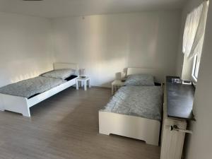 a bedroom with two beds and a table at L8 Street - Leimen - Basement floor in Leimen
