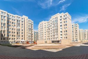 a group of large white buildings on a street at Expo new life 2 in Prigorodnyy
