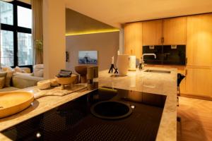 a kitchen with a counter with a sink in it at Newly renovated luxurious 200 SQM loft in city centre in Amsterdam