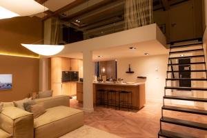 een woonkamer en een keuken met een bank en een bar bij Newly renovated luxurious 200 SQM loft in city centre in Amsterdam