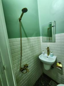 a white bathroom with a sink and a shower at Hathor House in Cairo +97 photos