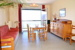 a living room with a couch and a table and chairs at Résidence Torremagne 8 in Font-Romeu-Odeillo-Via