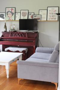 a living room with a piano and a couch at Haus Strandleben in Hohwacht