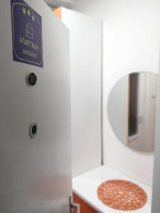 a bathroom with a sign on the door of a sink at Apartman studio Oranž in Kladovo