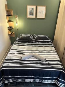 a bed with two towels on top of it at Appartement Tremblay en France in Tremblay En France