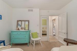 a room with a blue dresser and a mirror at Painted Porch Cottage in Lakeside