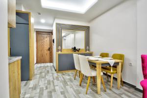 a dining room with a table and chairs and a mirror at North Blue Life in Istanbul