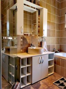 a bathroom with a sink and a mirror at 391 Vaal de Grace Golf Estate, Parys in Parys