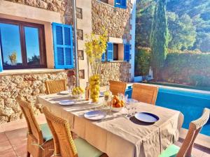 a dining room with a table and chairs at VILLA SOFIA in Valldemossa