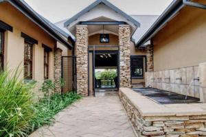 a home with a stone walkway leading to the front door at 391 Vaal de Grace Golf Estate, Parys in Parys